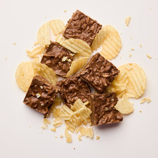 Chocolate bars and potato chips on a light background