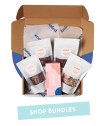 Coated Australia - Shop by Pre Made Gift Boxes and bundles. Chocolate. Chocolate Coated products. Australian made. Made in Melbourne. Open gift box filled with multiple chocolate bags and box of marshmallows with 'shop bundles' title.