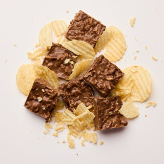 Chocolate bars and potato chips on a light background